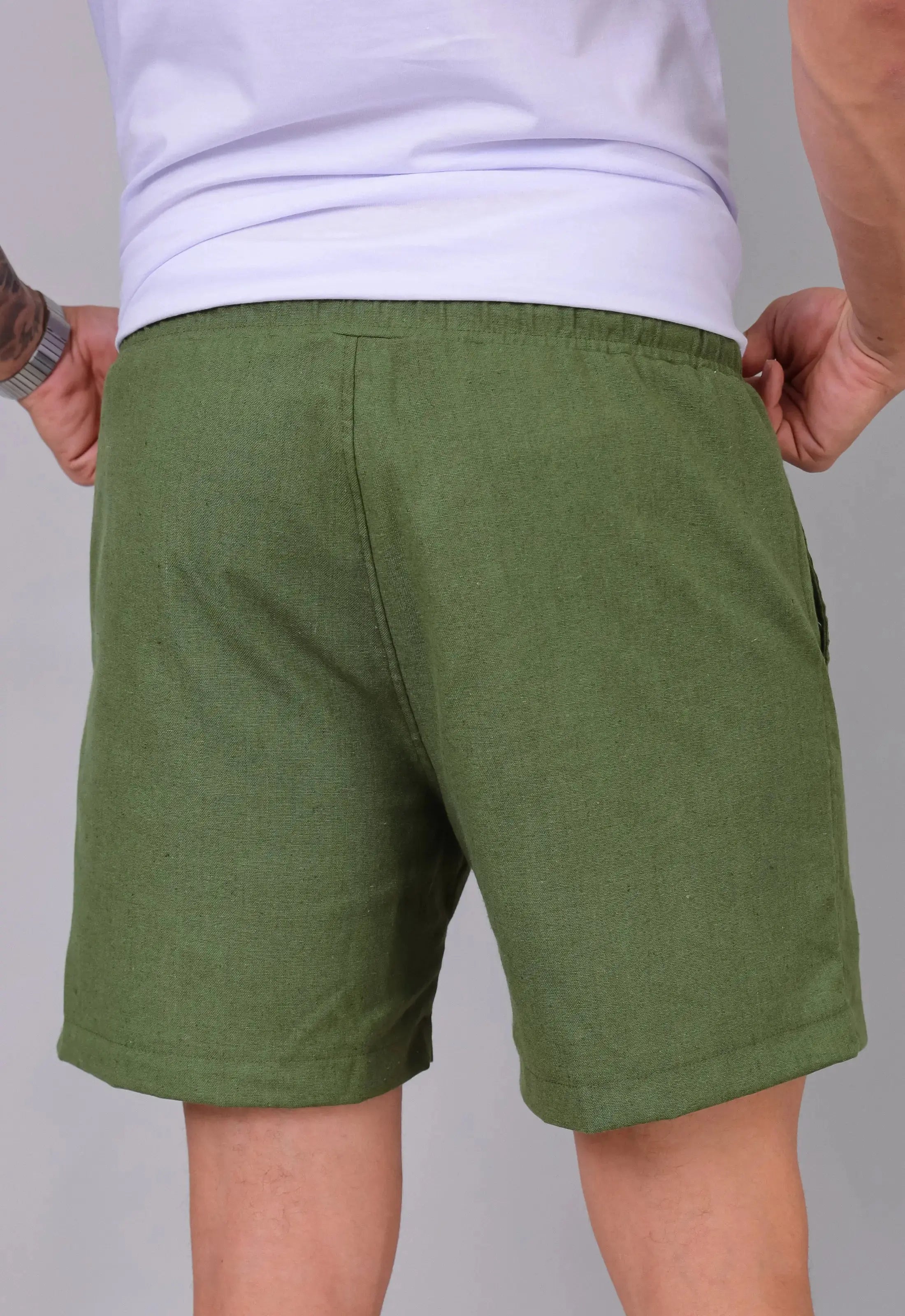 Vista de costas do shorts masculino de linho verde, mostrando os bolsos traseiros e o caimento — moda masculina CW Store